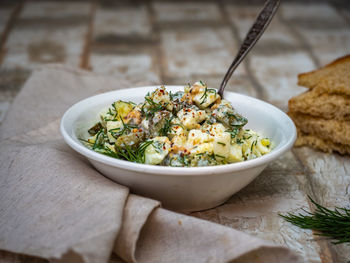 Simple dietary salad with eggs and cucumbers, with yoghurt dressing and spices, dill herbs 