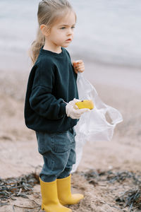 Side view of girl standing on field