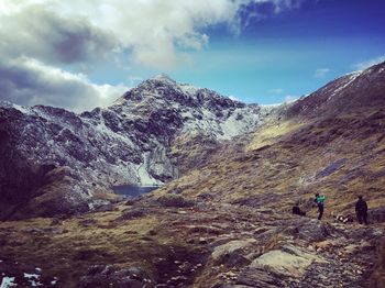 People walking on rocky landscape