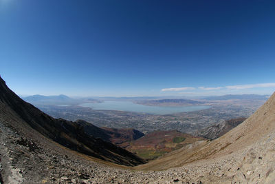 Scenic view of mountains against blue sky