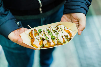 Midsection of man holding food takoyaki in japan