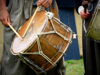 Midsection of drummers during medieval fair