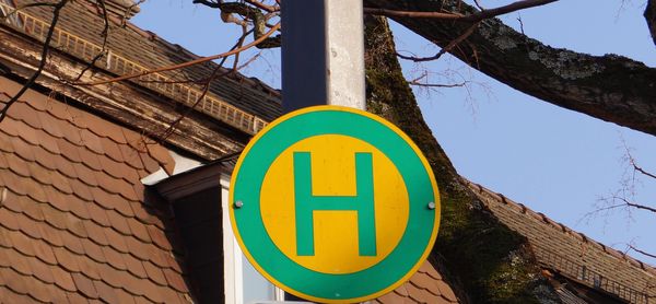 Low angle view of road sign against sky