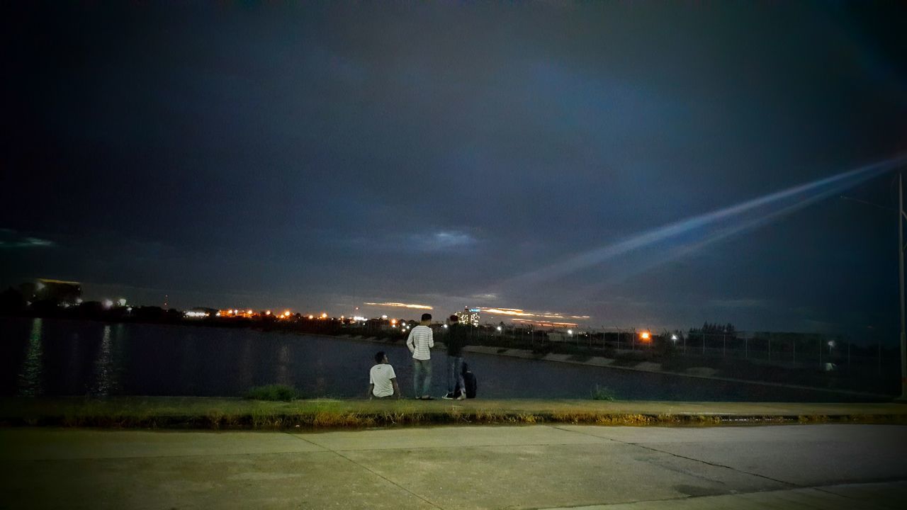 VIEW OF ILLUMINATED CITY AT NIGHT