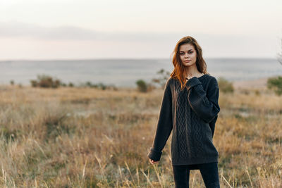 Young woman standing on field