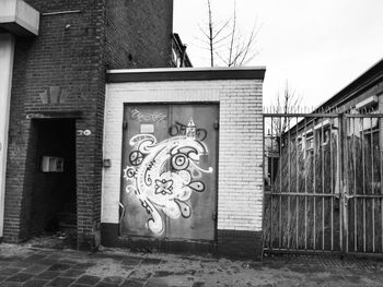 Graffiti on building against clear sky