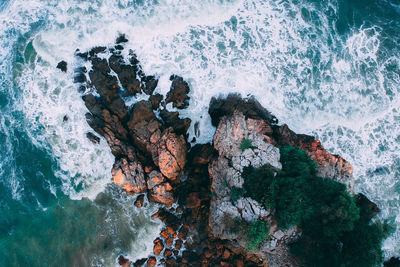 Scenic view of rocks on sea shore