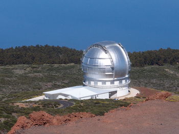 Built structure on land against clear blue sky