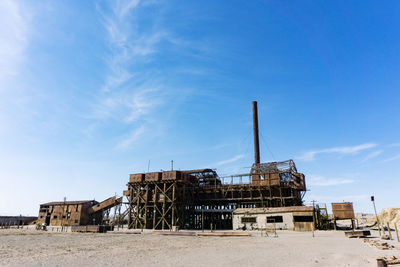 Abandoned construction site against blue sky