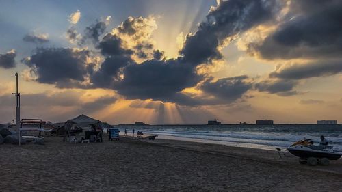 Scenic view of beach against sky during sunset