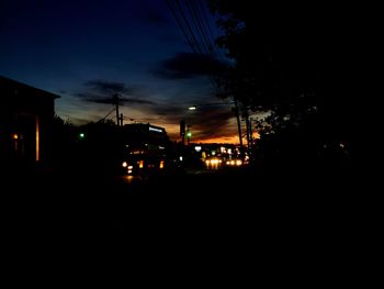 Silhouette of building against sky at night