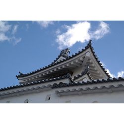 Low angle view of building against cloudy sky