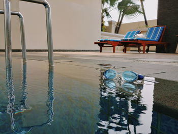 Chairs by swimming pool in lake