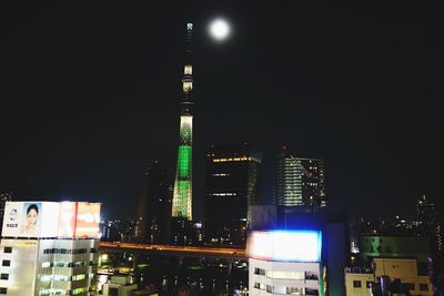 Low angle view of skyscrapers lit up at night