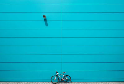 Bicycle against blue wall