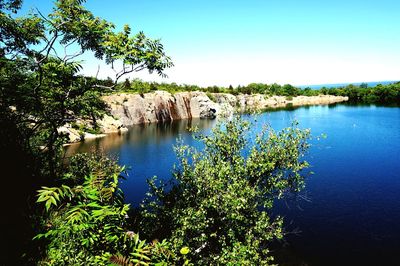 Scenic view of lake against clear blue sky