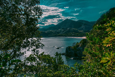 Scenic view of lake and mountains against sky