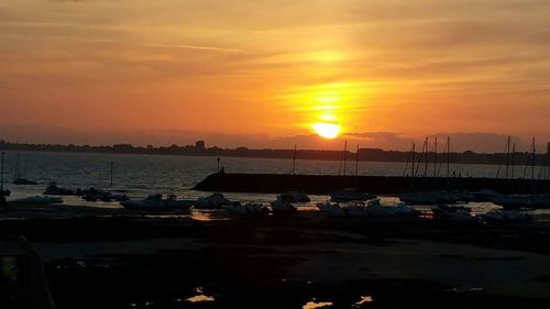 Boat in sea at sunset