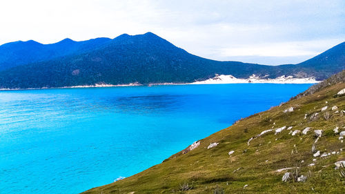 Scenic view of mountains against blue sky