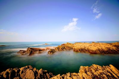 Scenic view of sea against blue sky