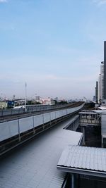 High angle view of railroad tracks by buildings against sky