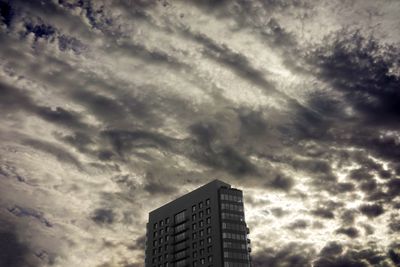 Low angle view of building against cloudy sky