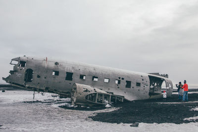 Airplane on runway against sky