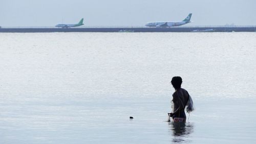 Man on sea against sky