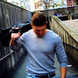 Midsection of man standing on bridge