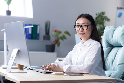 Young businesswoman working at desk in office