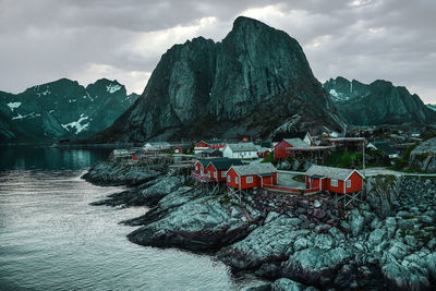 Scenic view of sea by mountains against sky