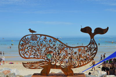 Bird statue on beach