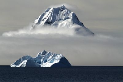 Scenic view of mountains against cloudy sky