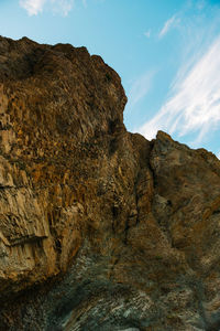 Low angle view of rock formation against sky