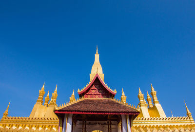 Low angle view of temple building against clear blue sky