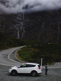 Cars on road against mountain