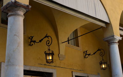 Low angle view of street light against building