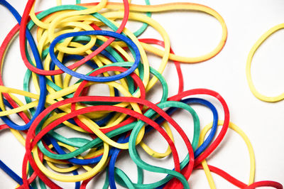 Close-up of colorful rubber bands over white background