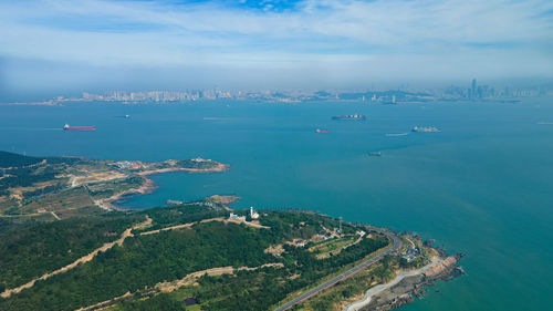 High angle view of sea and cityscape against sky