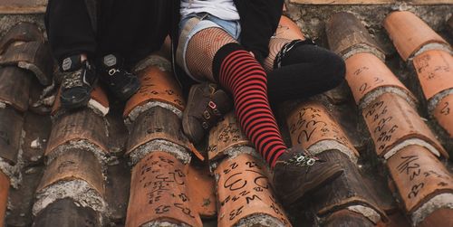 Low section of people sitting on rooftop