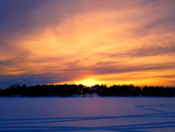 Scenic view of snow covered landscape against romantic sky