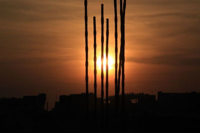 Silhouette buildings against sky during sunset