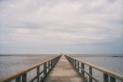 Pier over sea against sky