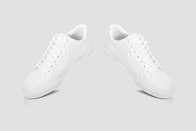 Close-up of shoes over white background