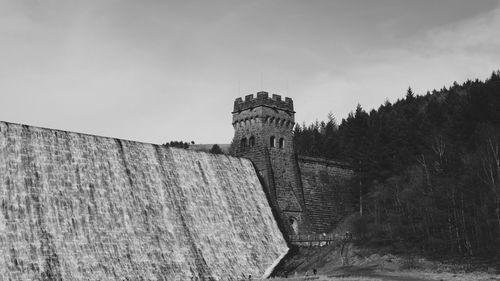 Low angle view of derwent dam against sky