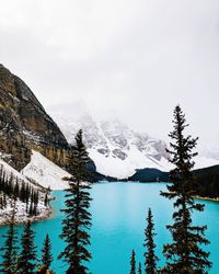 Scenic view of lake by mountains against sky