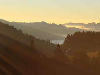 Scenic view of silhouette mountains against sky during sunset