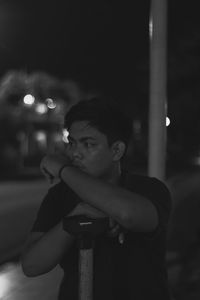 Portrait of boy looking away at night