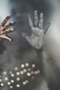 Close-up of human hands on glass