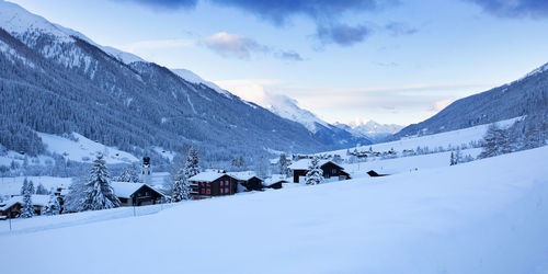 Scenic view of snow covered mountains against sky